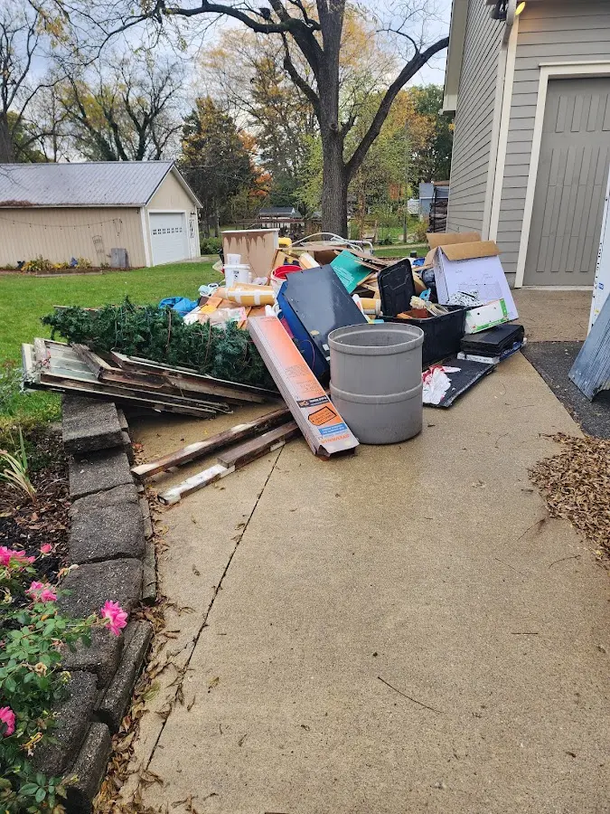 Dumpster being loaded with debris for 3 Yard Dumpster Rental in North Dansville